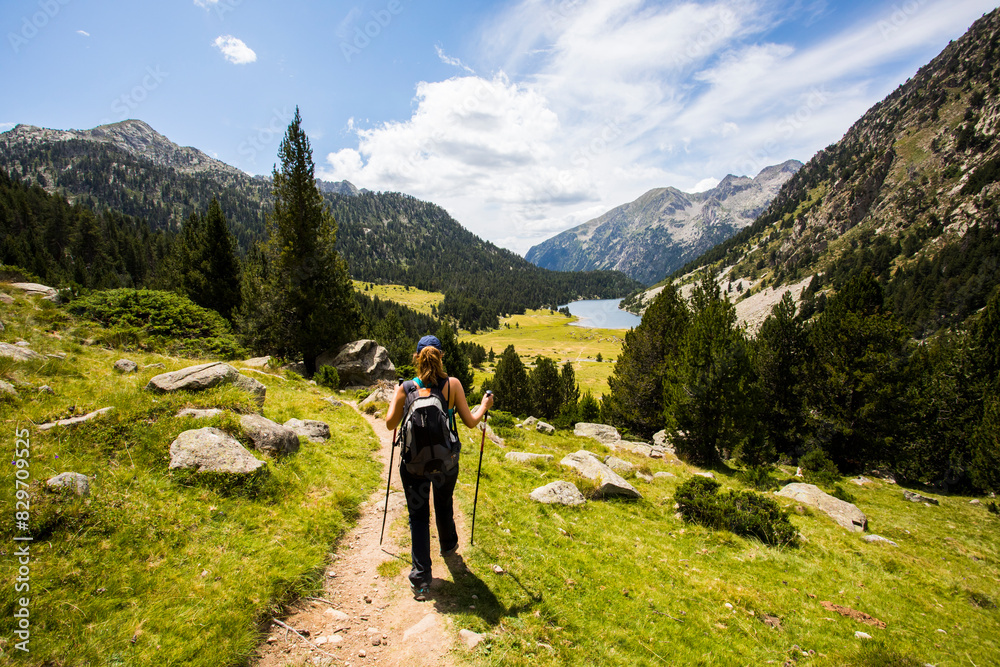 Young hiker woman in Vall de Boi, Aiguestortes and Sant Maurici National Park, Spain Young hiker woman in Vall de Boi, Aiguestortes and Sant Maurici National Park, Spain