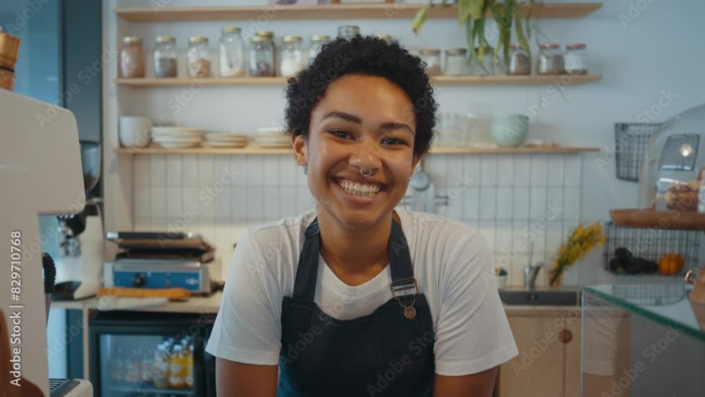 Beautiful woman working in a nordic styled cafe smiling in camera. Beautiful woman working in a nordic styled cafe smiling in camera.