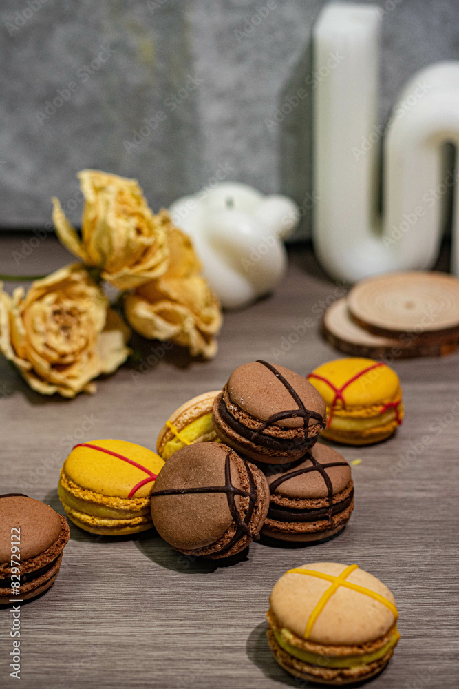 several macaroons and roses are laying out on a table several macaroons and roses are laying out on a table