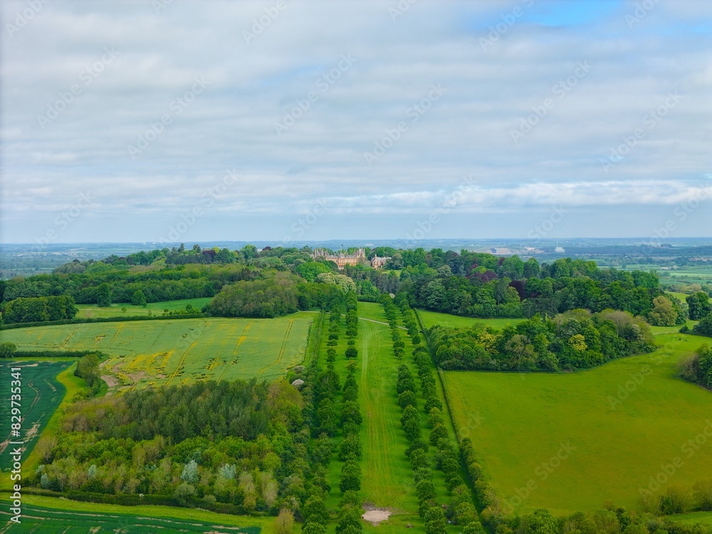 Aerial view of Waddesdon Manor atop a hill surrounded by lush green fields in Buckinghamshire. Aerial view of Waddesdon Manor atop a hill surrounded by lush green fields in Buckinghamshire.