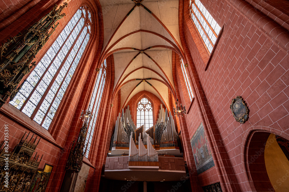 Cathedral interior with red brick walls and an organ Cathedral interior with red brick walls and an organ