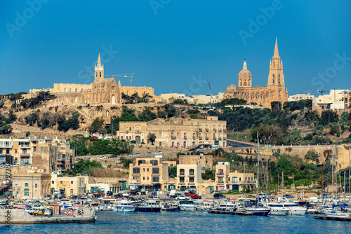 Mgarr bustling waterfront on the Gozitan isle, a scenic maritime hub showcasing Malta irresistible appeal as a Mediterranean paradise. Malta travel destination. photo