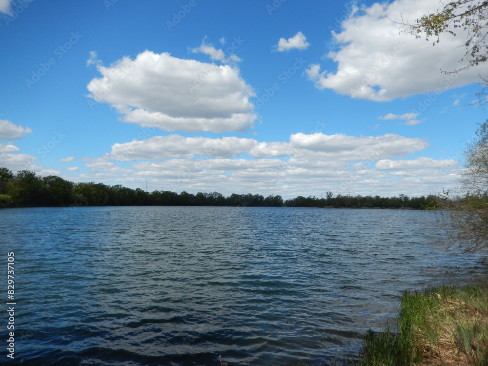 Scenic city-adjacent lake devoid of vegetation Scenic city-adjacent lake devoid of vegetation