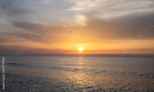 Stunning sunrise with the orange sky as the sun rises over the ocean.