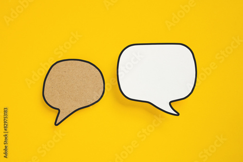 For conceptual image about communication and social media, customer feedback, real blank white and grunge brown speech bubble paper cut on yellow background