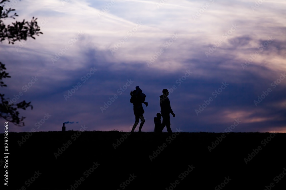 Silhouette of a parent and child against the sky Silhouette of a parent and child against the sky