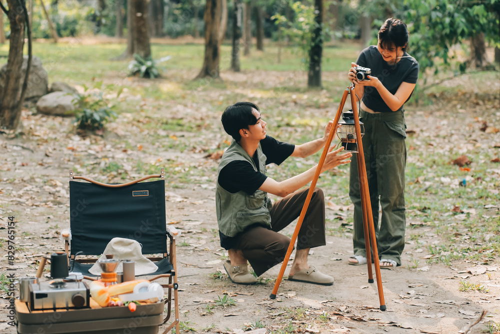 Asian couple sweet in tent inside on they camping trip, traveller relax and sleep togather in out door and camping trip Asian couple sweet in tent inside on they camping trip, traveller relax and sleep togather in out door and camping trip