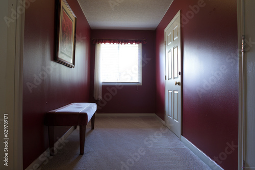 Small hallway with red walls featuring a bench and window