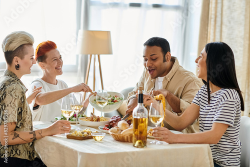 Fotografi A diverse group of people sitting around a table, eating delicious food and enjoying each others company