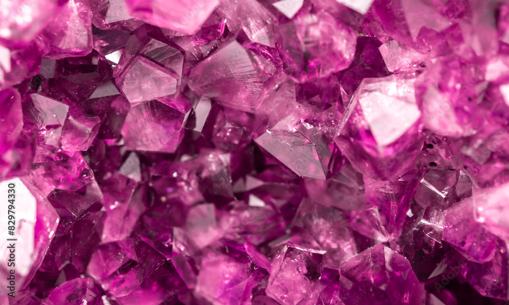 Amethyst pink crystals. Gems. Mineral crystals in the natural environment. Texture of precious and semiprecious stones. Seamless background with copy space colored shiny surface of precious stones.