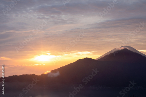 Sunrise over Mount Batur with a golden sky and silhouetted mountains. Travel © Виктория Попова