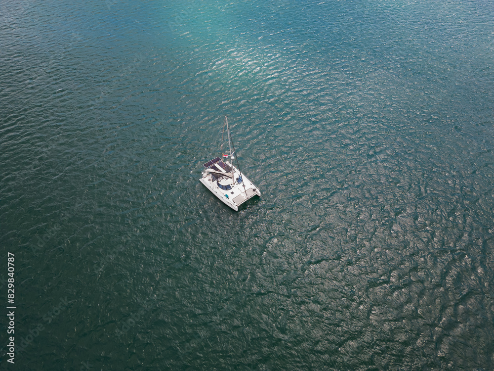 A yacht with solar panels sails in the Atlantic Ocean on a spring day, drone point of view. A yacht with solar panels sails in the Atlantic Ocean on a spring day, drone point of view.