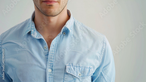 Man wearing rumpled light blue shirt on white background photo