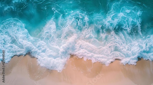 Highangle shot of the ocean waves, capturing the beauty of the clear, wavy blue water The image includes generous copy space, suitable for various marketing and advertising needs