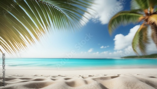 Beautiful blurred beach background  white sandy shore and azure water  a few palm trees sway