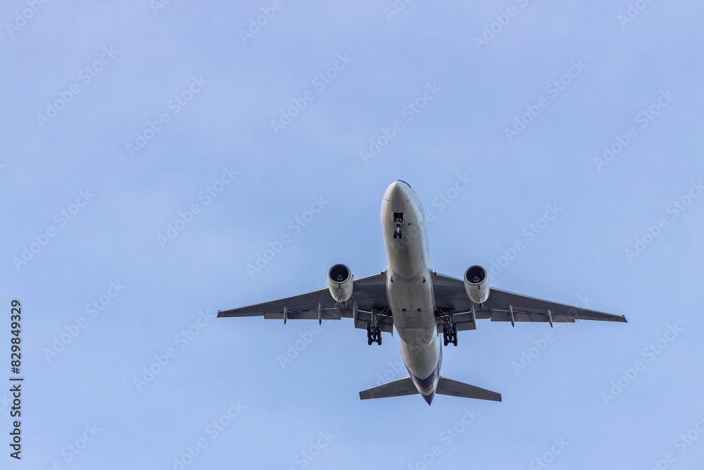 Airplane and sky, the plane is landing. Airplane take off on the blue sky, Aircraft flying on sky background. Passenger plane ready for landing. Low angle view of Airplane flying under blue sky. Airplane and sky, the plane is landing. Airplane take off on the blue sky, Aircraft flying on sky background. Passenger plane ready for landing. Low angle view of Airplane flying under blue sky.