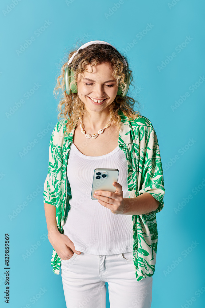 Woman with headphones and green shirt enjoys music on phone. Woman with headphones and green shirt enjoys music on phone.