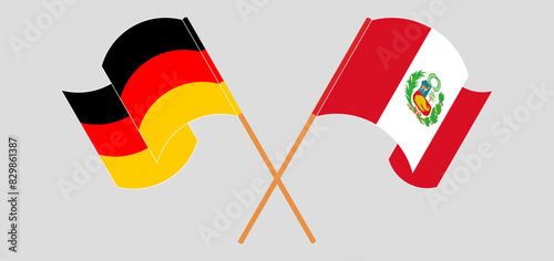 Crossed and waving flags of Germany and Peru
