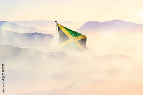 Jamaica flag disappears in beautiful clouds with fog.