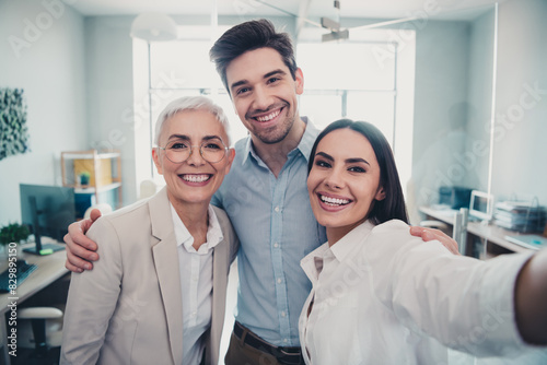 Photo of business people making selfie picture in modern office