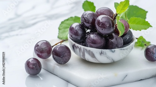 fresh ripe Jabuticaba on white marble bowl isolated on white background. Generative Ai photo