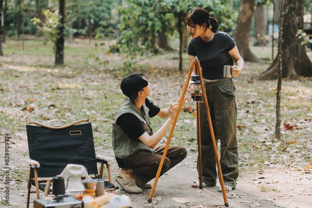 Asian couple sweet in tent inside on they camping trip, traveller relax and sleep togather in out door and camping trip Asian couple sweet in tent inside on they camping trip, traveller relax and sleep togather in out door and camping trip