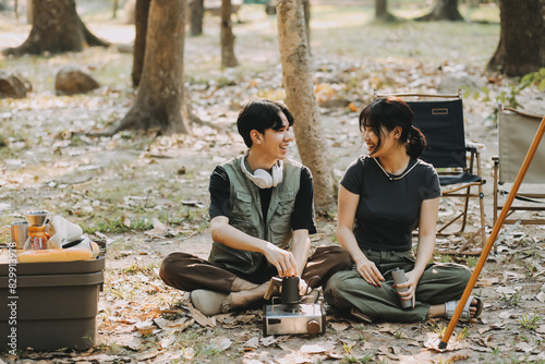 Asian couple sweet in tent inside on they camping trip, traveller relax and sleep togather in out door and camping trip © ARMMY PICCA