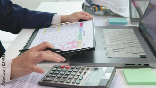 Expert woman asian female people review data number costing managerial account prepare monthly actual cost variance report at tax audit office. ESG sheet budget control ERP process service project.