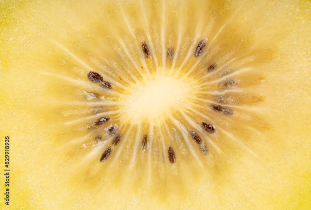 Background of a juicy half of a gold kiwi fruit close-up