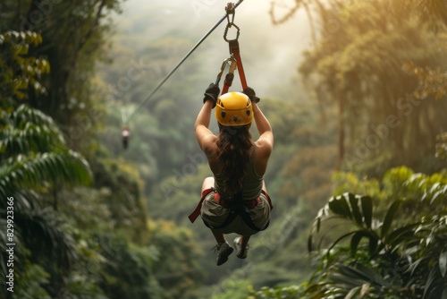 a man riding a zipline through a lush green forest, An adventurer zip-lining through the tropical rainforest in Costa Rica photo