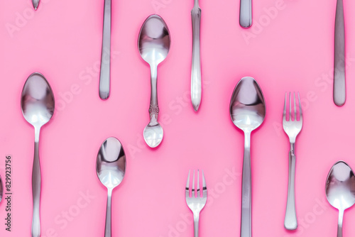 Spoons and forks on pastel background - seamless pattern