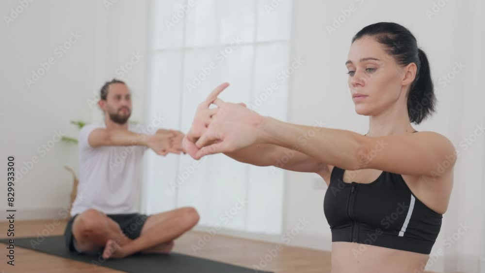 Group Yoga Class in a Bright Studio with Instructor Giving Guidance Group Yoga Class in a Bright Studio with Instructor Giving Guidance