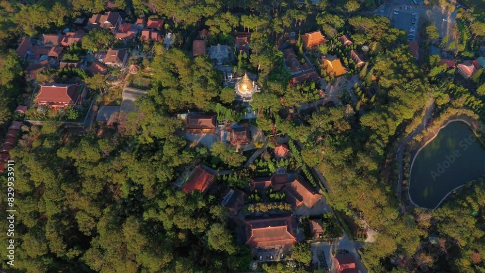 Aerial view of Truc Lam thien vien or Spiriturality monastery on top of the hill, a religion destination when travel Tuyen Lam tourist area, green pine forest landscape with group of tile roof house