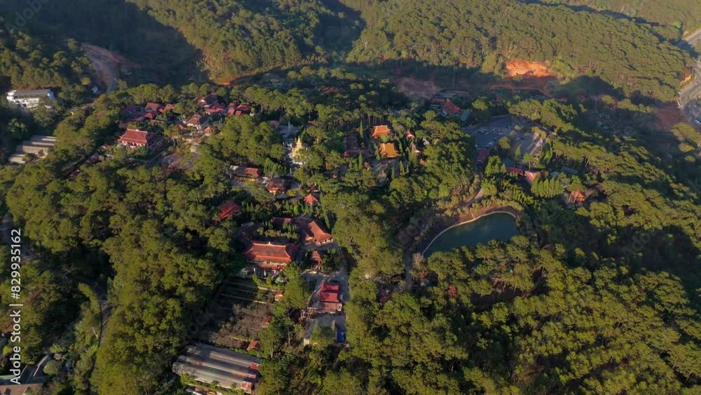 Aerial view of Truc Lam thien vien or Spiriturality monastery on top of the hill, a religion destination when travel Tuyen Lam tourist area, green pine forest landscape with group of tile roof house