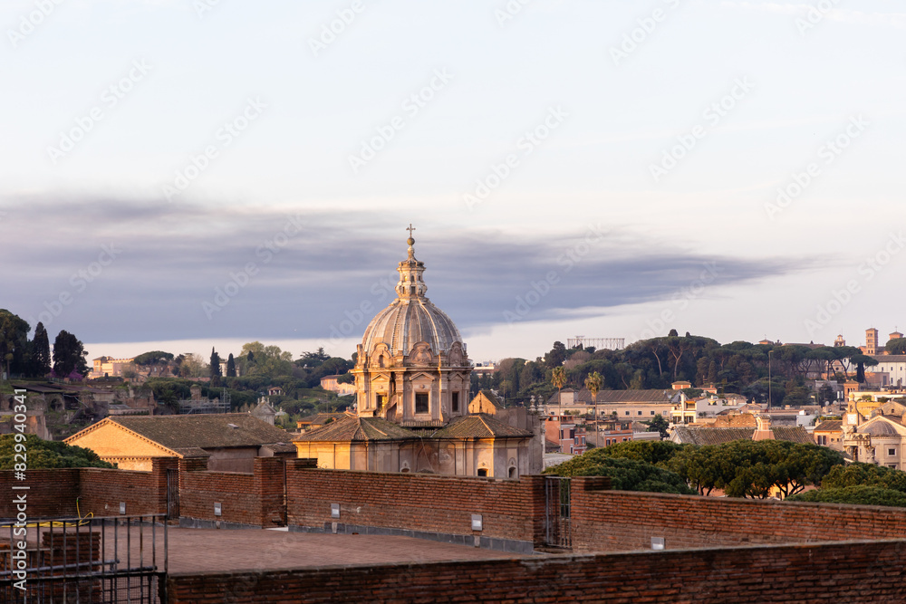 Fototapeta premium Rome, Italy - April 09, 2024: View of the streets at sunrise in Rome with tourists crowding its surroundings in Rome, Italy