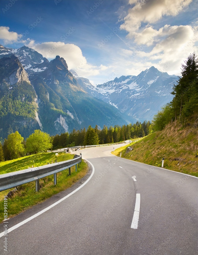 Fototapeta premium transport road in the Alps against the backdrop of snow-capped mountains and forest