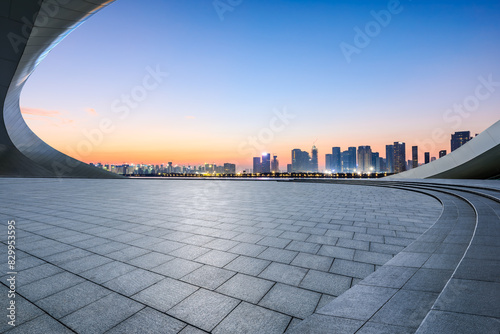 Obraz na płótnie Empty square floor and city skyline with modern buildings at sunrise w salonie