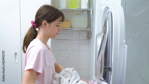 Teenager girl doing laundry at her home
