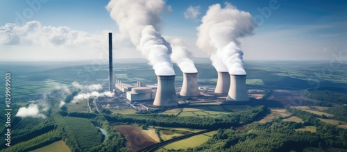 Fototapeta Naklejka Na Ścianę i Meble -  An aerial photograph showcases the Drax Power Station in North Yorkshire featuring smoking chimneys and cooling towers releasing CO2 into the atmosphere The image provides ample copy space