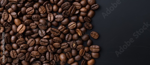 A gray background showcases roasted coffee beans and ground coffee with copy space The image is taken from a top down perspective