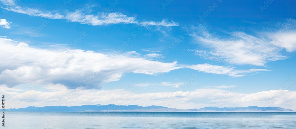 A picturesque landscape of QingHai lake with a panoramic view showcasing the serene bluesky and tranquil lake waters ideal for copy space images A picturesque landscape of QingHai lake with a panoramic view showcasing the serene bluesky and tranquil lake waters ideal for copy space images