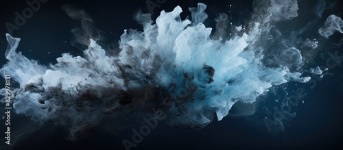 An abstract image capturing the frozen motion of black powder exploding or being thrown against a backdrop with empty space around it. with copy space image. Place for adding text or design photo