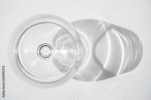 Fotografie Empty wine or shot glass seen from above with shadow on white background