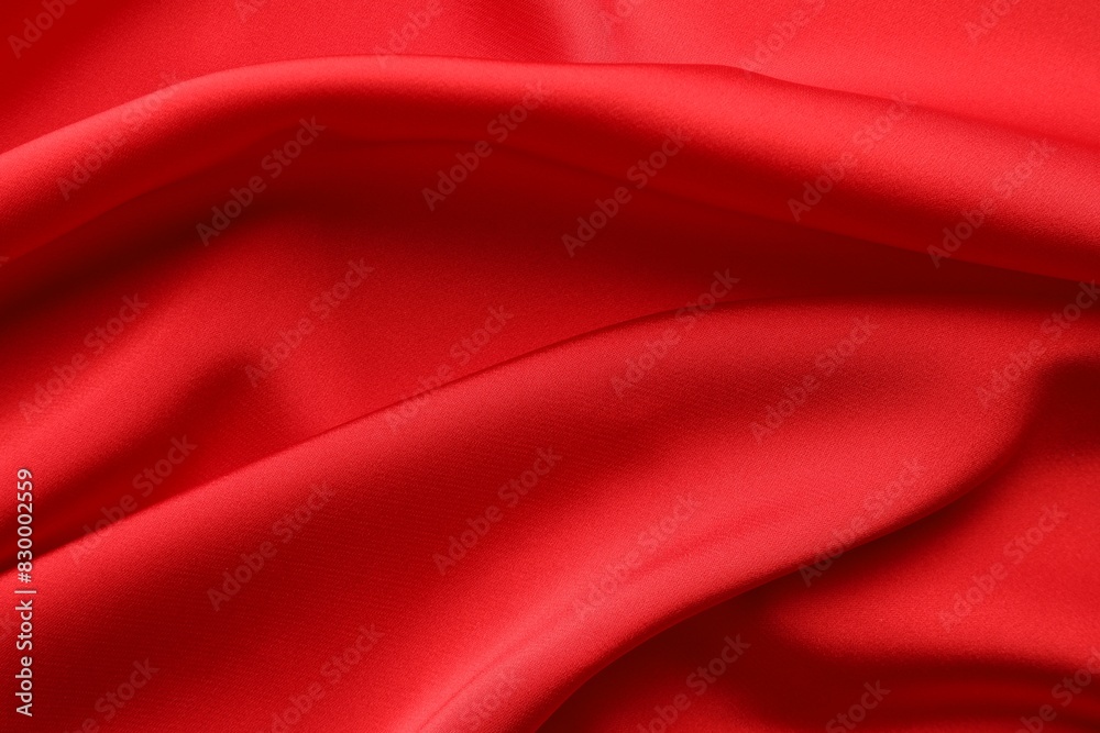 Crumpled red silk fabric as background, top view