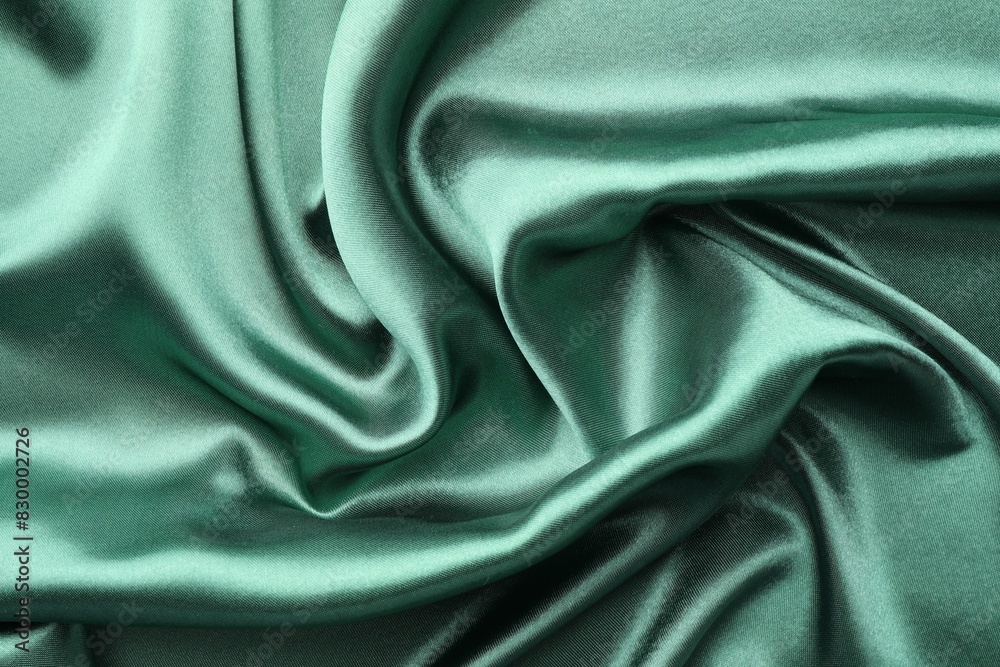 Fototapeta premium Crumpled green silk fabric as background, top view