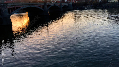 Canvas Print Rippling Vltava River in Prague as the sun rises over the old city