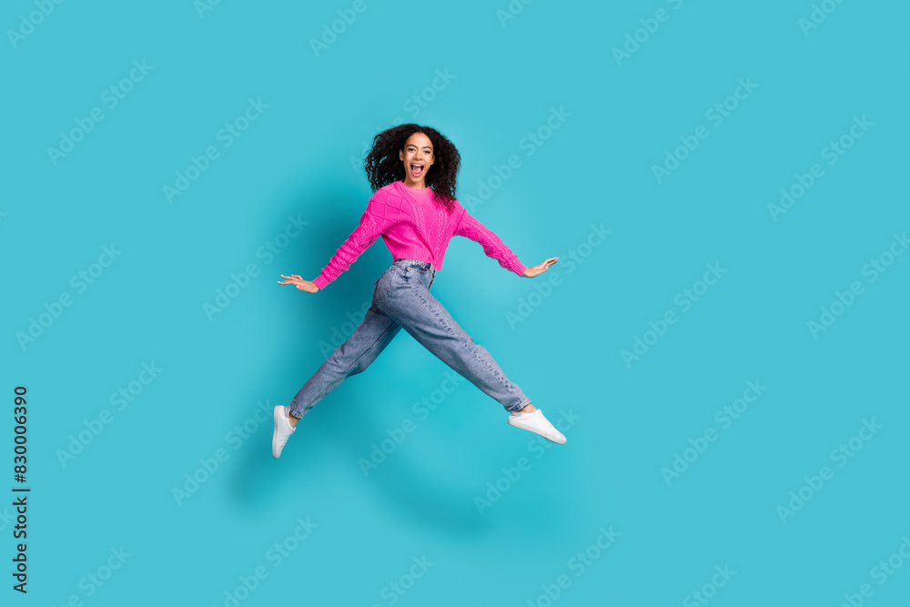 Full length photo of lovely teen lady running jump dressed stylish pink garment isolated on cyan color background