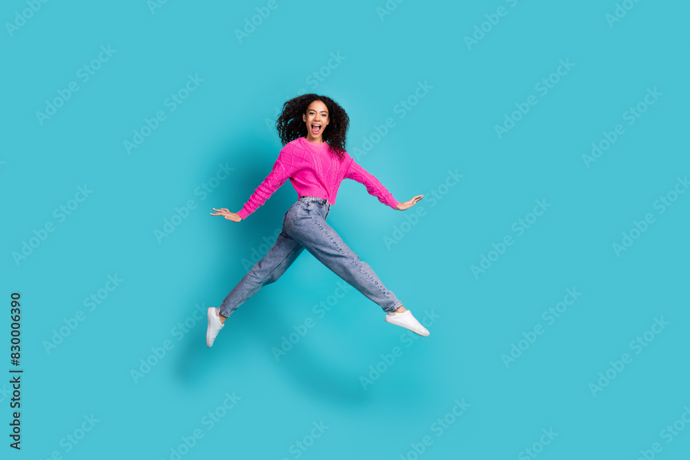 Full length photo of lovely teen lady running jump dressed stylish pink garment isolated on cyan color background Full length photo of lovely teen lady running jump dressed stylish pink garment isolated on cyan color background