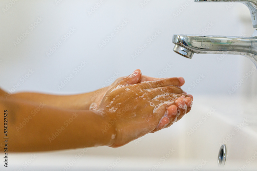 Fototapeta premium close up hands of children washing hands with soap under the faucet with water,copy space for text or product you. clean and Hygiene concept.
