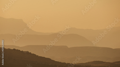 Warm mountain scenery with fog at dusk